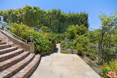 Tucked behind lush landscaping on one of the most coveted and on Los Angeles Country Club in California - for sale on GolfHomes.com, golf home, golf lot