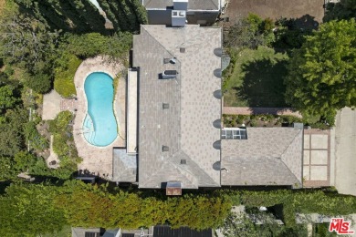 Tucked behind lush landscaping on one of the most coveted and on Los Angeles Country Club in California - for sale on GolfHomes.com, golf home, golf lot