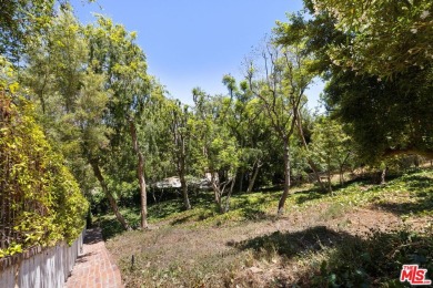 Tucked behind lush landscaping on one of the most coveted and on Los Angeles Country Club in California - for sale on GolfHomes.com, golf home, golf lot