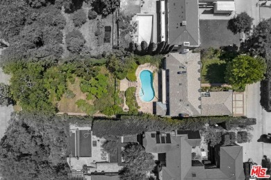 Tucked behind lush landscaping on one of the most coveted and on Los Angeles Country Club in California - for sale on GolfHomes.com, golf home, golf lot