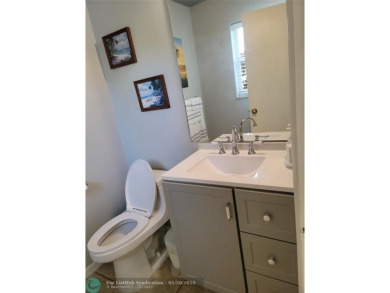Nestled in the highly sought-after, gated golf course community on Atlantic National Golf and Country Club in Florida - for sale on GolfHomes.com, golf home, golf lot