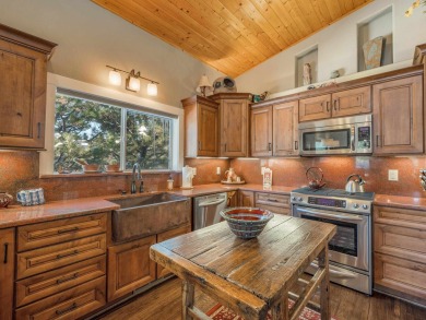 Nestled on an expansive 1.9-acre lot surrounded by whispering on Angel Fire Resort Country Club in New Mexico - for sale on GolfHomes.com, golf home, golf lot