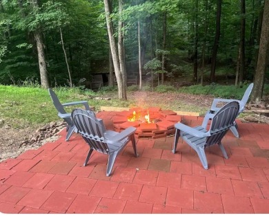 Welcome to this authentic Cape Cod-style log cabin in the heart on Apple Valley Golf Course in Ohio - for sale on GolfHomes.com, golf home, golf lot
