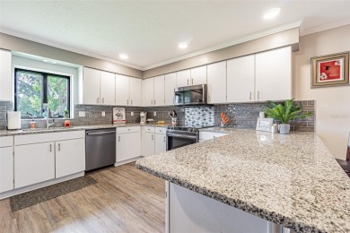 PICTURE PERFECT and perched on a large, serene POND, this on Tampa Bay Golf and Country Club in Florida - for sale on GolfHomes.com, golf home, golf lot