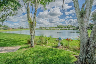 PICTURE PERFECT and perched on a large, serene POND, this on Tampa Bay Golf and Country Club in Florida - for sale on GolfHomes.com, golf home, golf lot