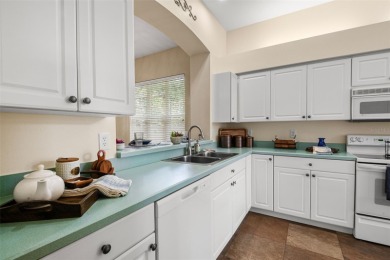 Walk up as you take in the lush landscape and brick paved front on East Lake Woodlands Country Club in Florida - for sale on GolfHomes.com, golf home, golf lot