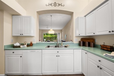 Walk up as you take in the lush landscape and brick paved front on East Lake Woodlands Country Club in Florida - for sale on GolfHomes.com, golf home, golf lot