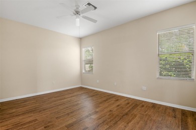 Walk up as you take in the lush landscape and brick paved front on East Lake Woodlands Country Club in Florida - for sale on GolfHomes.com, golf home, golf lot