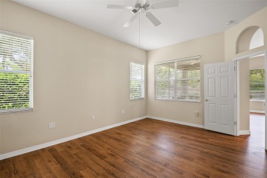 Walk up as you take in the lush landscape and brick paved front on East Lake Woodlands Country Club in Florida - for sale on GolfHomes.com, golf home, golf lot