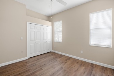 Walk up as you take in the lush landscape and brick paved front on East Lake Woodlands Country Club in Florida - for sale on GolfHomes.com, golf home, golf lot