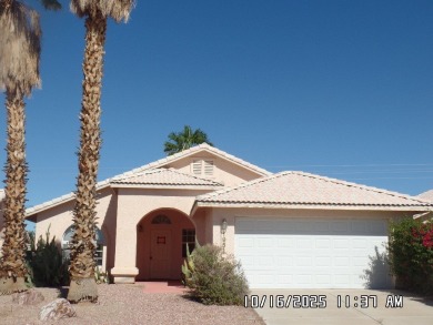 Fairway Estates home, with front landscaping and mature palm on Desert Lakes Golf Course in Arizona - for sale on GolfHomes.com, golf home, golf lot