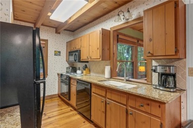 Discover the perfect mountain escape in this charming 3-bedroom on Big Canoe Golf Club - Cherokee in Georgia - for sale on GolfHomes.com, golf home, golf lot