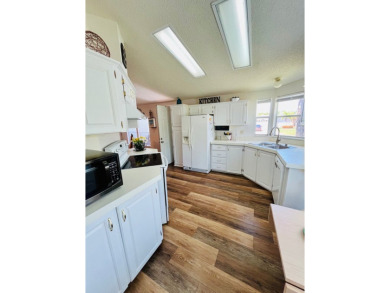 This two-bedroom, two-bathroom home in the gated golf community on Pine Lakes Country Club in Florida - for sale on GolfHomes.com, golf home, golf lot