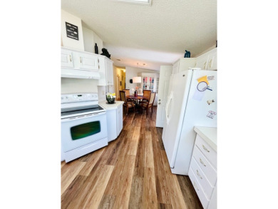 This two-bedroom, two-bathroom home in the gated golf community on Pine Lakes Country Club in Florida - for sale on GolfHomes.com, golf home, golf lot