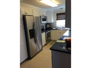 Under contract-accepting backup offers. LOWEST PRICED SFR on Key Royale Club in Florida - for sale on GolfHomes.com, golf home, golf lot