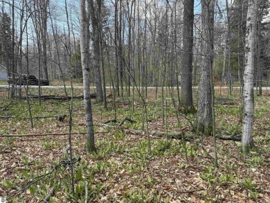 Surrounded by the natural beauty of mature hardwoods and on Manitou Passage Golf Club in Michigan - for sale on GolfHomes.com, golf home, golf lot