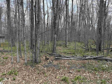 Surrounded by the natural beauty of mature hardwoods and on Manitou Passage Golf Club in Michigan - for sale on GolfHomes.com, golf home, golf lot