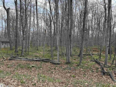 Surrounded by the natural beauty of mature hardwoods and on Manitou Passage Golf Club in Michigan - for sale on GolfHomes.com, golf home, golf lot