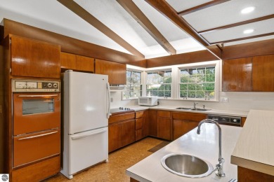 Mid-century modern classic, designed by renowned Charlevoix on Charlevoix Golf Club in Michigan - for sale on GolfHomes.com, golf home, golf lot