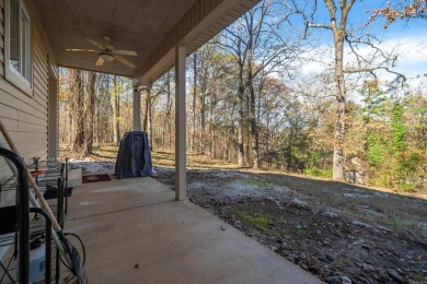 Nestled on a serene wooded lot in the Diamondhead community on Diamondhead Golf and Country Club in Arkansas - for sale on GolfHomes.com, golf home, golf lot