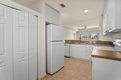 If you want relaxing, tranquil water views and beautiful sunsets on Sabal Trace Golf and Country Club in Florida - for sale on GolfHomes.com, golf home, golf lot