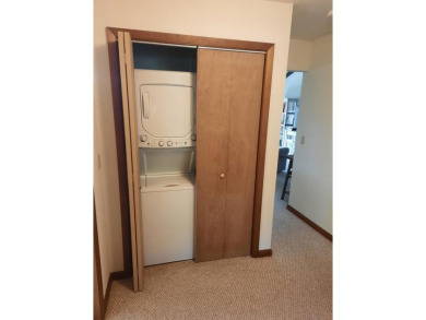 This first-floor unit offers a large living room with vaulted on Bay Ridge Golf Course in Wisconsin - for sale on GolfHomes.com, golf home, golf lot