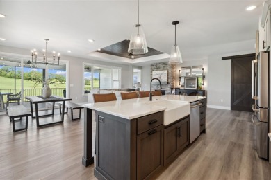 This 2024 Parade of Homes by Hodge Construction overlooks the on Saddleback Ridge Golf Course in Iowa - for sale on GolfHomes.com, golf home, golf lot