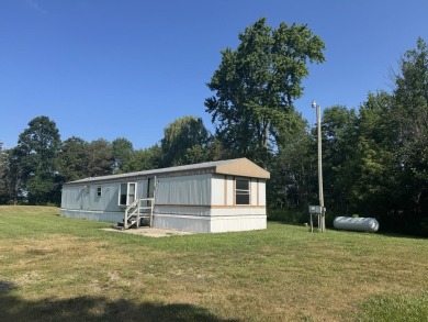 Looking for affordable country living? This charming 2-bedroom on Beeches Golf Club  in Michigan - for sale on GolfHomes.com, golf home, golf lot