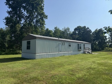 Looking for affordable country living? This charming 2-bedroom on Beeches Golf Club  in Michigan - for sale on GolfHomes.com, golf home, golf lot