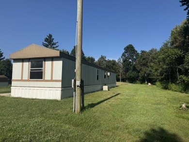Looking for affordable country living? This charming 2-bedroom on Beeches Golf Club  in Michigan - for sale on GolfHomes.com, golf home, golf lot