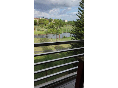 Beautiful view from balcony of golf course and water this 2/2 is on Poinciana Golf Club in Florida - for sale on GolfHomes.com, golf home, golf lot