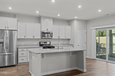 Greeted by a stacked-stone, covered front porch and classic on The Club At Twelve Oaks in North Carolina - for sale on GolfHomes.com, golf home, golf lot