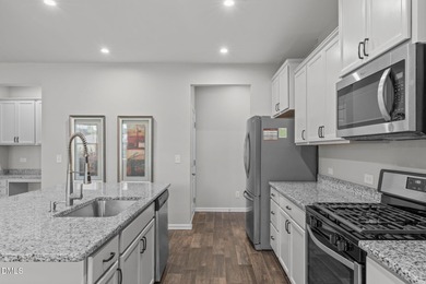 Greeted by a stacked-stone, covered front porch and classic on The Club At Twelve Oaks in North Carolina - for sale on GolfHomes.com, golf home, golf lot