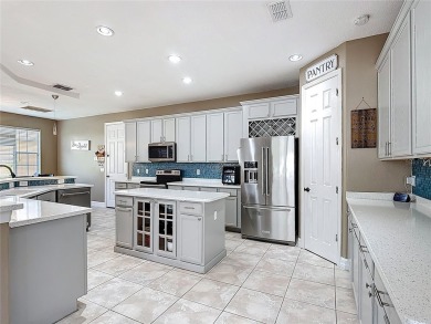 Stunning 5-Bedroom Pool Home on Expansive Corner Lot with Water on Oaks National Golf Course in Florida - for sale on GolfHomes.com, golf home, golf lot