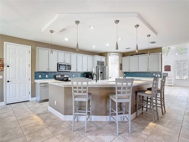 Stunning 5-Bedroom Pool Home on Expansive Corner Lot with Water on Oaks National Golf Course in Florida - for sale on GolfHomes.com, golf home, golf lot