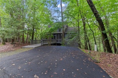 Discover the perfect mountain escape in this charming 3-bedroom on Big Canoe Golf Club - Cherokee in Georgia - for sale on GolfHomes.com, golf home, golf lot