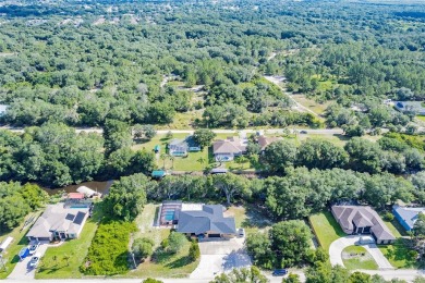 5 BED 3 BATH WATERFRONT CANAL POOL HOME WITH WATER ACCESS TO THE on Deep Creek Golf Club in Florida - for sale on GolfHomes.com, golf home, golf lot