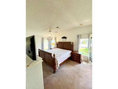This two-bedroom, two-bathroom home in the gated golf community on Pine Lakes Country Club in Florida - for sale on GolfHomes.com, golf home, golf lot