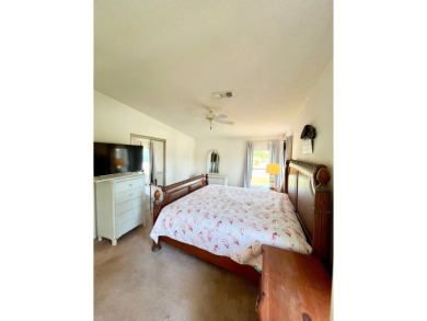 This two-bedroom, two-bathroom home in the gated golf community on Pine Lakes Country Club in Florida - for sale on GolfHomes.com, golf home, golf lot