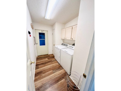 This two-bedroom, two-bathroom home in the gated golf community on Pine Lakes Country Club in Florida - for sale on GolfHomes.com, golf home, golf lot
