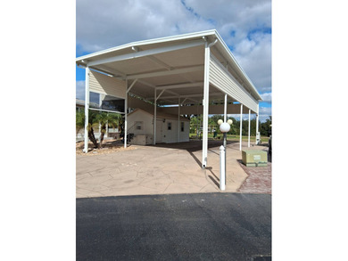 LARGE RV LOT WITH OVERSIZED PORT, BEDROOM, BATH, PATIO AREA AND on Deer Creek RV Golf Resort in Florida - for sale on GolfHomes.com, golf home, golf lot