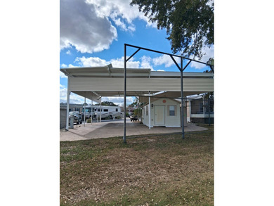 LARGE RV LOT WITH OVERSIZED PORT, BEDROOM, BATH, PATIO AREA AND on Deer Creek RV Golf Resort in Florida - for sale on GolfHomes.com, golf home, golf lot