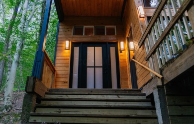 Amid towering hemlocks, this modern cabin reveals the quiet on Hide-A-Way Hills Golf Club in Ohio - for sale on GolfHomes.com, golf home, golf lot