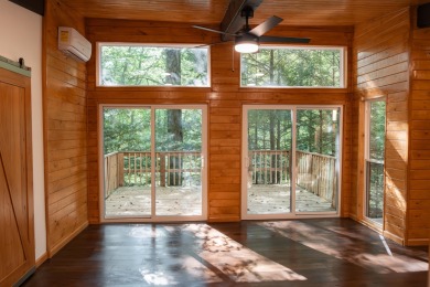 Amid towering hemlocks, this modern cabin reveals the quiet on Hide-A-Way Hills Golf Club in Ohio - for sale on GolfHomes.com, golf home, golf lot