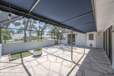 Gorgeous paver driveway and lush landscaping greet you as you on Indian River Colony Club in Florida - for sale on GolfHomes.com, golf home, golf lot