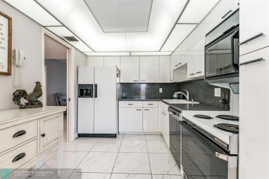 EXPERIENCE DRAMATIC WATER VIEWS FROM THIS CORNER TURNKEY UNIT! on Palm-Aire Country Club and Resort - Palms in Florida - for sale on GolfHomes.com, golf home, golf lot