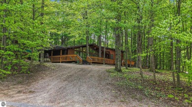 Anchor your Northern Michigan adventures at this architecturally on The Chief Golf Course in Michigan - for sale on GolfHomes.com, golf home, golf lot