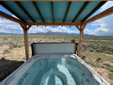 Situated on 6.77 acres spanning three independent parcels (two on Taos Country Club in New Mexico - for sale on GolfHomes.com, golf home, golf lot