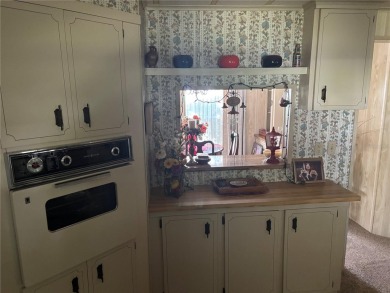 Spacious 2-bedroom, 2-bath home on a large corner lot with over on Zellwood Station Country Club in Florida - for sale on GolfHomes.com, golf home, golf lot