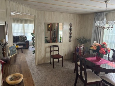 Spacious 2-bedroom, 2-bath home on a large corner lot with over on Zellwood Station Country Club in Florida - for sale on GolfHomes.com, golf home, golf lot